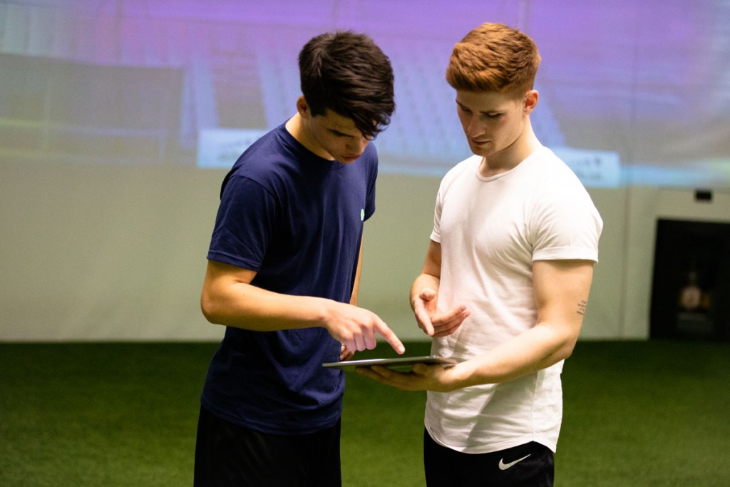 Individual training - Image showing a player and a coach discussing performance data