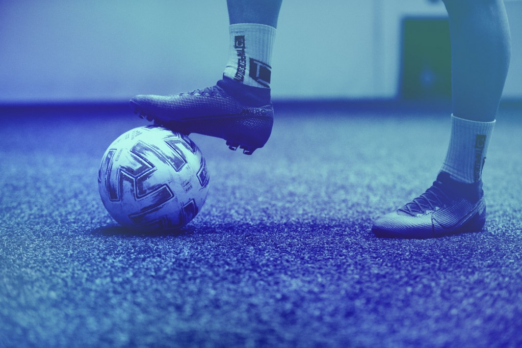 Detail shot of a football and a player's foot